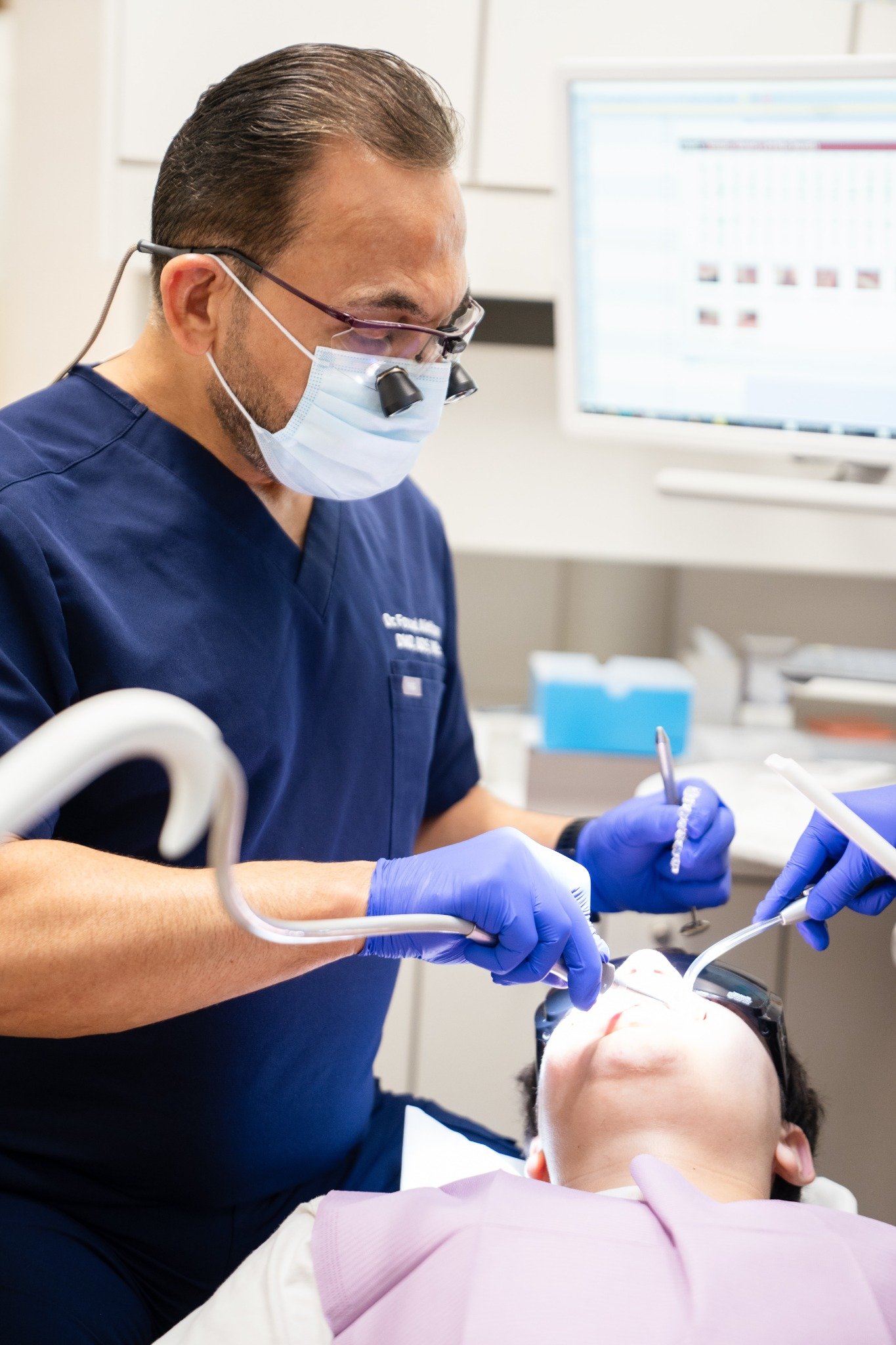 Dr. Fouad Alethawy providing dental treatment at Monalisa Dental Centre