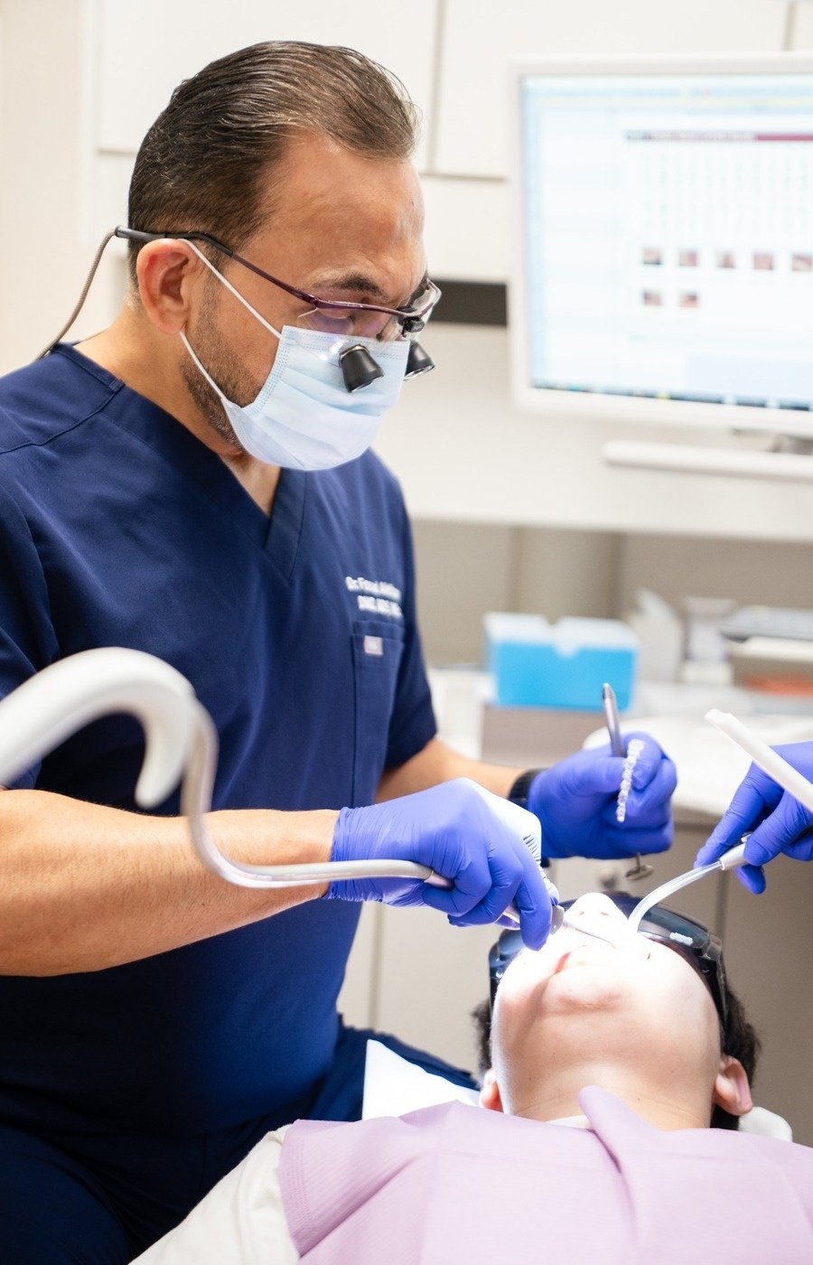 Dr. Fouad providing dental treatment